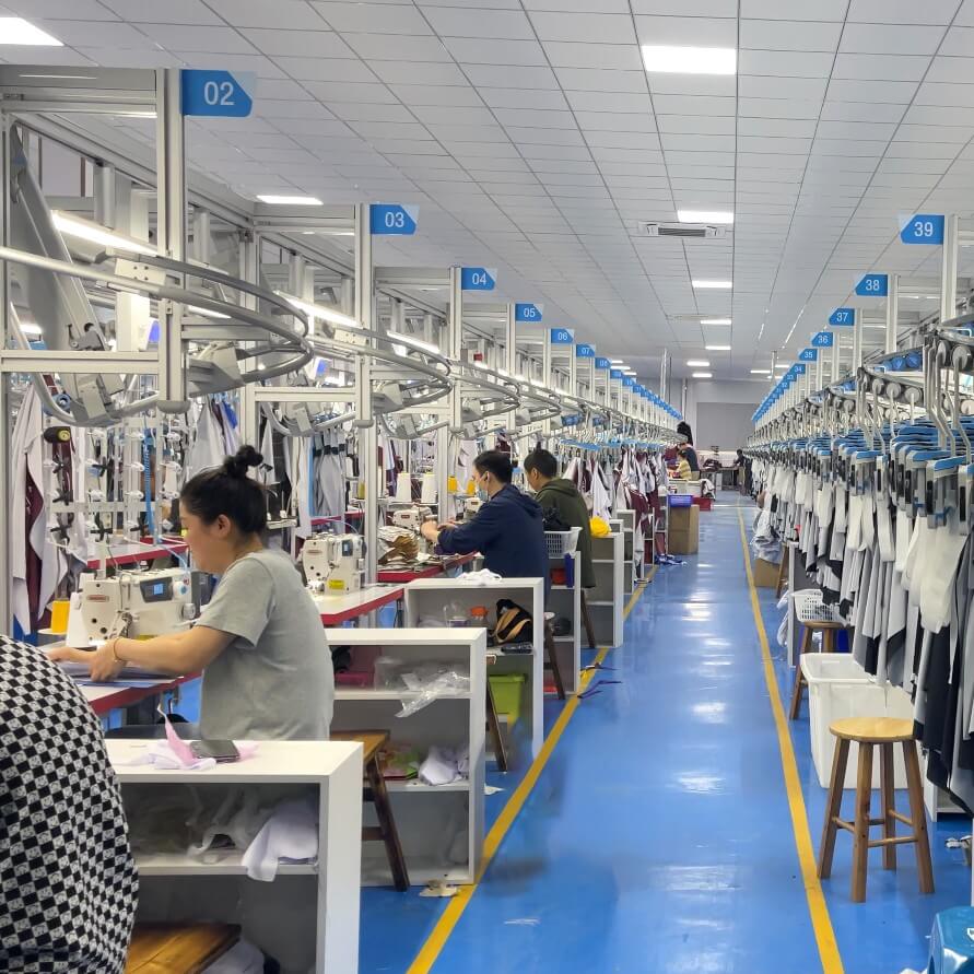 workers in sportswear sewing workshop